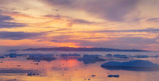 setting sun on Disko bay Greenland.