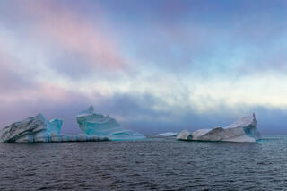 Iceberg  in sea mist in Disko bay Greenland 
