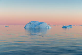 remains of iceberg in the midnight setting sun on Disko Bay Greenland.