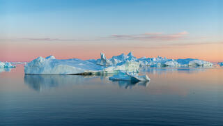 icebergs in setting sun in Greenland Disko bay