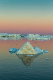Remains of icebergs on Disko Bay Greenland in the midnight sun