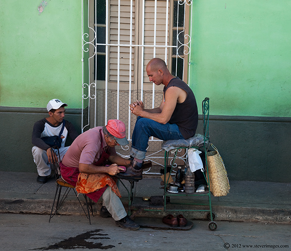 Shining shoes outdoors, Trinidad, Cuba, Image of man shining shoes outdoor in Trinida