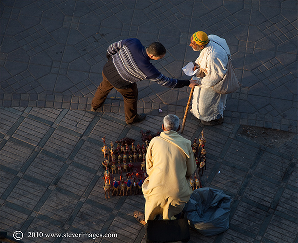 An overhead view of a brief interaction in Djemma-el-Fna square, Marrakech