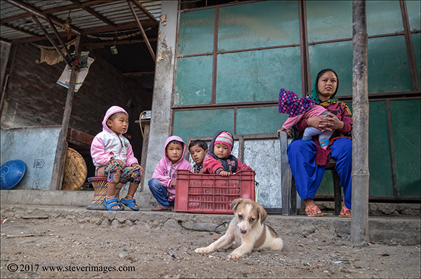 Picture of family outdoors with dog in Nepal.